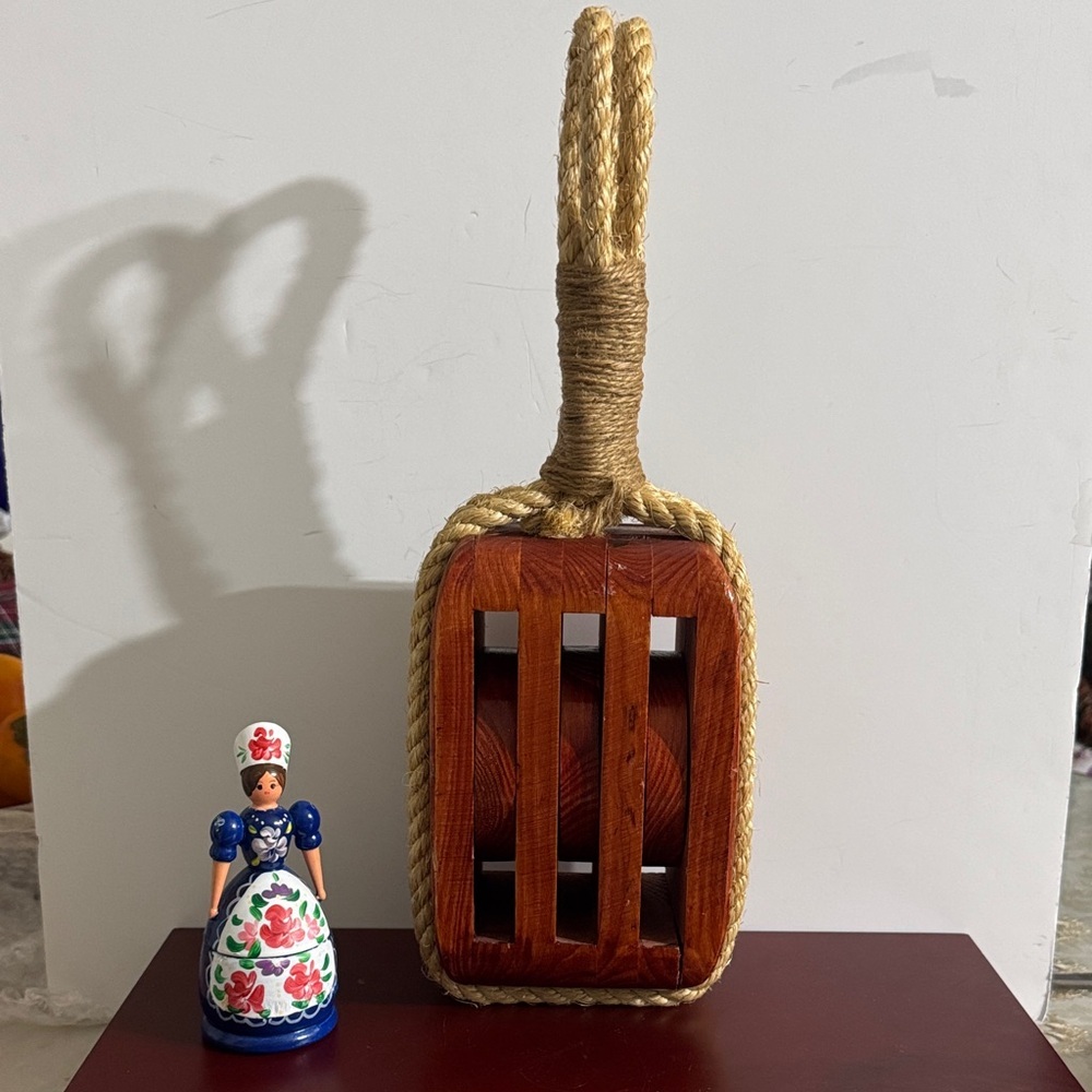decorative wooden triple pulley, often made as a rustic reproduction